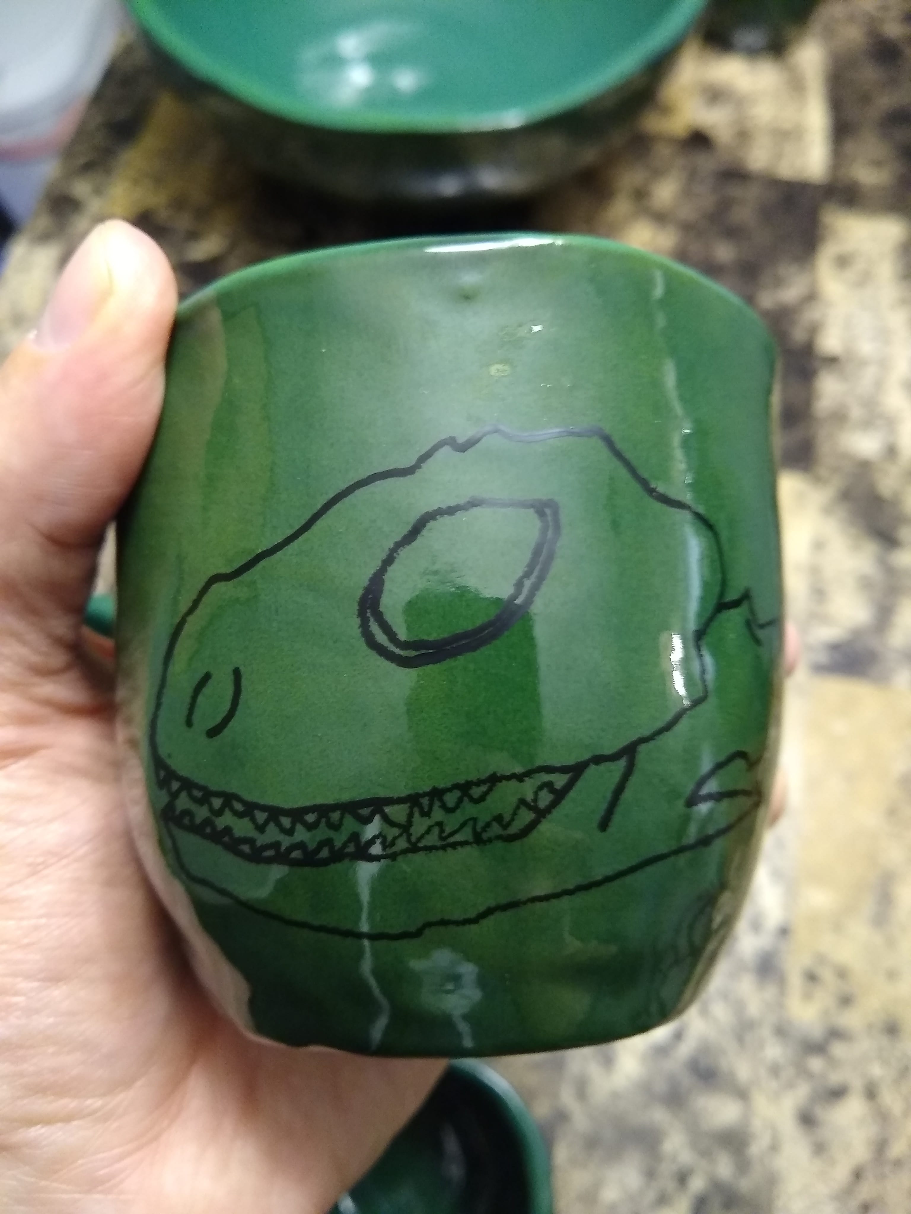 mug with iguana skull drawn on it